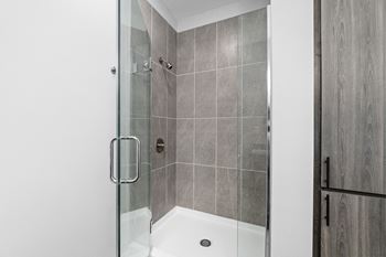 A modern bathroom with a walk-in shower.